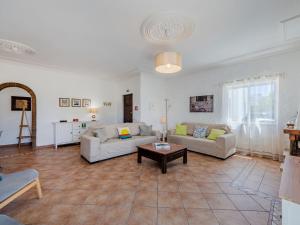 a living room with two couches and a table at Holiday Home Casa do Sol by Interhome in Patroves