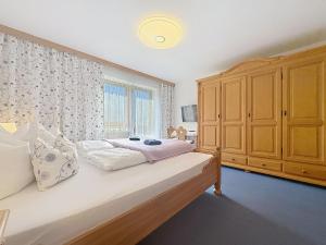 a bedroom with a bed and a large window at Apartment Appartements Binderhof-1 by Interhome in Aschau