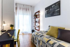 a bedroom with a bed and a table with a television on the wall at Casa Giordano in Rome