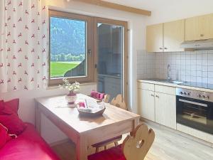 a kitchen with a table and a table and a dining room at Apartment Appartements Binderhof-1 by Interhome in Aschau +40 photos