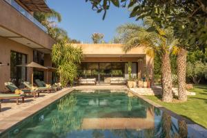 a swimming pool in the backyard of a house at Palais Nohe in Marrakesh
