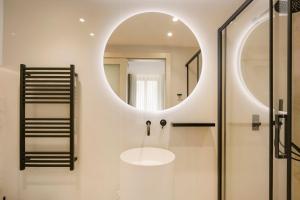 a bathroom with a sink and a mirror at The Three Doors in St. Julianʼs +44 photos