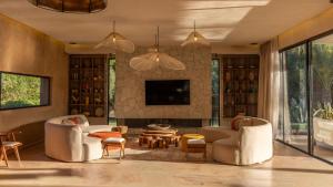 a living room with two couches and a tv at Palais Nohe in Marrakesh