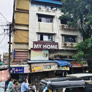 a building with a sign that reads hurt my home at Hotel My Home Dormitory in Boisar