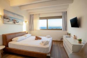 a hotel room with a bed with a window at Villa Mare 2 - Private Pool, Sea View, Starlink, 4 Bdrms in Hanioti +51 photos