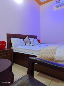 a bedroom with two beds with white pillows at Green Hotel in Jīnd +13 photos