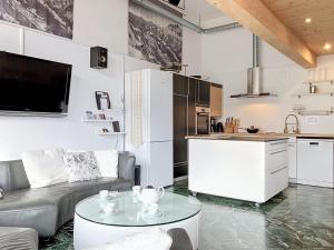 a kitchen and living room with a couch and a table at Apartment Les Cimes by Interhome in Les Crosets