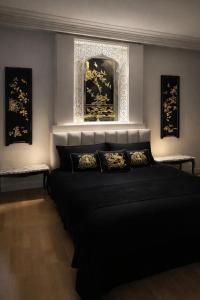 a bedroom with a black bed and a mirror at Fantastic 6B Villa in Sidi Daoud +47 photos