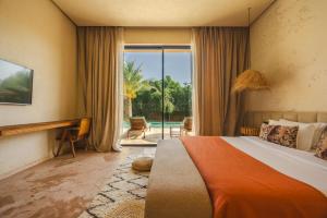 a bedroom with a bed and a view of a pool at Palais Nohe in Marrakesh +53 photos