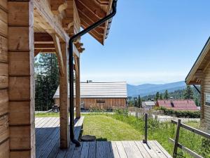 a wooden deck with a view of a barn at Chalet Chalet Amsel by Interhome in Hochrindl