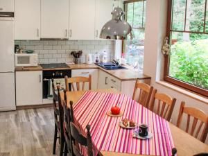 a kitchen with a table with a plate of food on it at Holiday Home Karpacz Kowary by Interhome in Kowary +20 photos