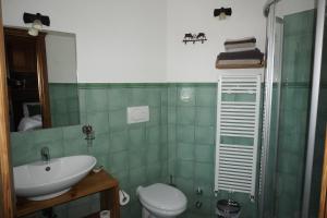 a bathroom with a sink and a toilet and a mirror at B&B Petit in Sauze dʼOulx +20 photos