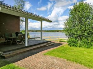 a porch of a house with a view of the water at Holiday Home Suvela by Interhome in Kukkola