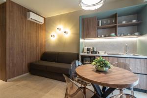 a living room with a table and a couch at Dimora Nòva Verona in Verona