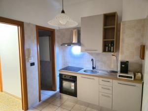 a small kitchen with a sink and a stove at HAKUNA MATATA Elegant Apartment in Central Taranto in Taranto