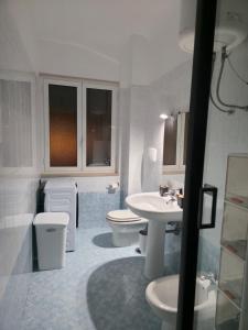 a white bathroom with two toilets and a sink at HAKUNA MATATA Elegant Apartment in Central Taranto in Taranto +17 photos