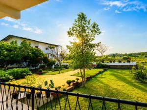 a view from the balcony of a house with a yard at Ceylon Breeze Sigiriya in Sigiriya