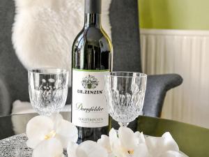 a bottle of wine and two wine glasses on a table at Apartment Siebers by Interhome in Sebnitz