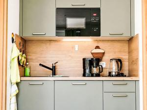 a kitchen with white cabinets and a sink at Apartment Siebers by Interhome in Sebnitz +12 photos