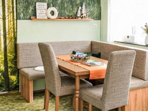 a dining room with a wooden table and chairs at Apartment Siebers by Interhome in Sebnitz