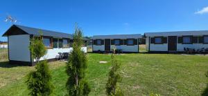 a row of mobile homes on a grass field at Domki Ostoja in Rewal