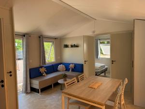 a living room with a table and a couch at Bahia 2 in Le Faulq +3 photos