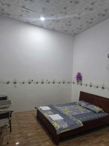 a bedroom with a bed in a white wall at nhà nghỉ Thịnh Phát in Xóm Hương Phùng