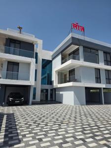 a building with a car parked in front of it at Hotel Nandanwan Resto and Bar in Mālsiras