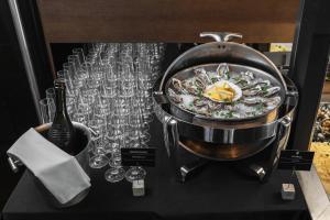 a bowl of food and wine glasses on a table at M1 Club Hotel in Odesa