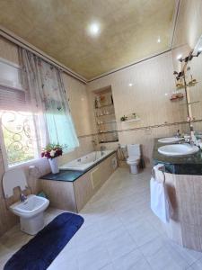 a bathroom with two sinks and a tub and a toilet at Morocco AG in Casablanca +39 photos
