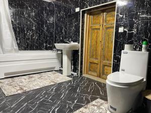 a bathroom with a toilet and a sink and a tub at Mulberry Hotel in Tashkent +63 photos