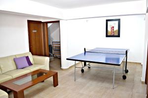 a living room with a table and a couch at Villa Saraliana Sandy Beach Villas - Heated Pool - Jacuzzi - Private Beach Area in Polis Chrysochous