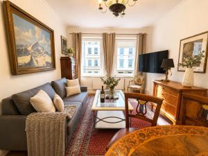 a living room with a couch and a table at Velmora Boutique Suites - Vintage Design Apartment in Altstadtnähe in Lübeck
