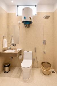 a bathroom with a toilet and a sink at Hotel 33 Inn in Kānpur