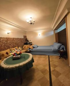 a bedroom with a bed and a table in a room at Morocco AG in Casablanca