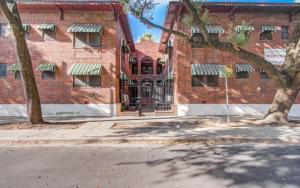 an empty street in front of a brick building at Cute Downtown Stay near Toyota Center & Midtown in Houston