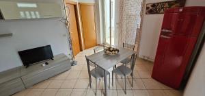 a kitchen with a small table and a red refrigerator at Petrucci House in Vasto