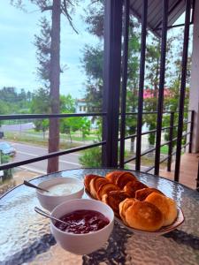 a table with a plate of croissants and dipping sauce at guest house buknari-eniseli in Chakvi