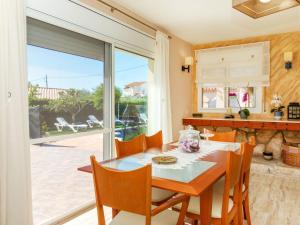 a dining room with a table and chairs and a large window at Villa Villa Cantos by Interhome in L'Ametlla de Mar