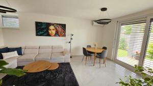 a living room with a couch and a table at Vila Castrum in Nové Zámky