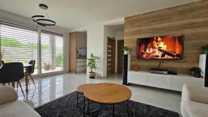a living room with a fireplace in the wall at Vila Castrum in Nové Zámky