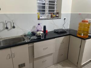 a kitchen with a sink and a counter top at Narayana Avenue , kondapur 2 Bhk in Hyderabad