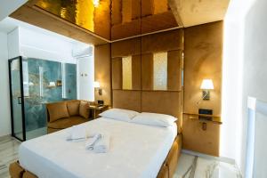 a bedroom with a large bed and a chair at Letoh Apartment in Catania +23 photos