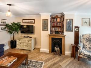 a living room with a fireplace and a tv at St Augustine's Stays - Stone Bay in Broadstairs