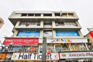a tall building with signs in front of it at Hotel keshav in Ahmedabad