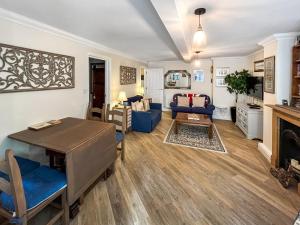 a living room with a table and a couch at St Augustine's Stays - Stone Bay in Broadstairs