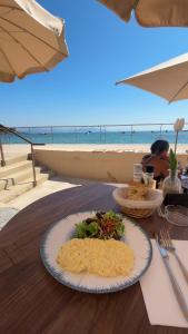 a plate of food on a table near the beach at Le Pavillon du Cap d'Antibes in Antibes