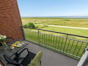 a balcony with a table and chairs and the ocean at Apartment Sofija by Interhome in Højer