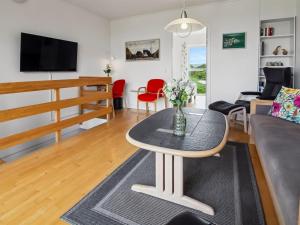 a living room with a table and a couch at Apartment Sofija by Interhome in Højer