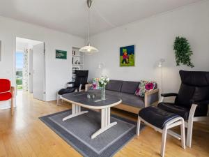 a living room with a couch and a table at Apartment Sofija by Interhome in Højer